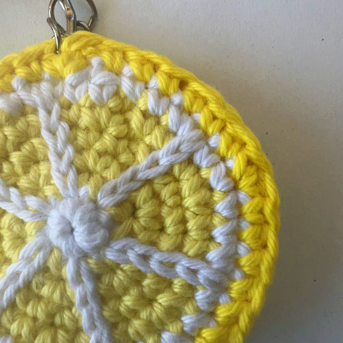 Close-up of hand-crocheted lemon keychain, cotton yarn detail — The Italian Stitch
